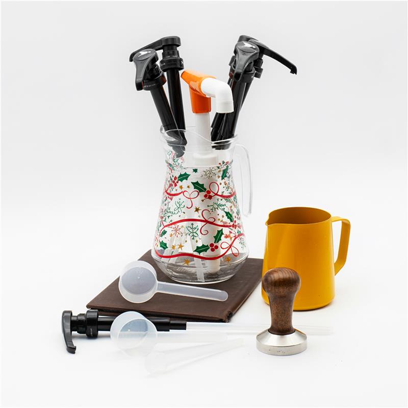 Coffee-making tools including a coffee scoop, and yellow mug on a white background.